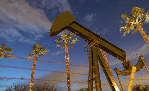 In this file photo pump jacks draw crude oil from the Long Beach Oil Field under Discovery Well Park in Signal Hill, California, on March 9, 2020. (AFP)