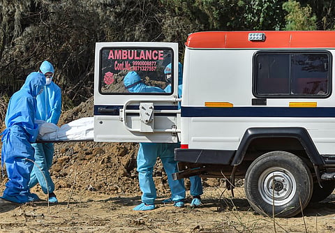 Medics and family members arrive to perform burial of a person who died of COVID-19 during the nationwide lockdown in New Delhi Wednesday April 22 2020. (Photo | PTI)