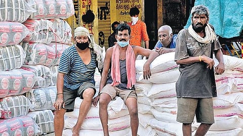 Daily wage labourers wait for work at a wholesale market in New Taragupet in Bengaluru on Wednesday  | Nagaraja Gadekal