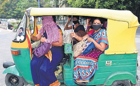Social distancing goes for a toss as government employees cram themselves into an autorickshaw on their way to work in Bengaluru  | Nagaraja Gadekal