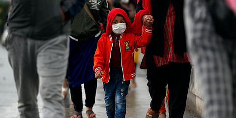 Nepalese people arrive to board a vehicle to go back to their village, during lockdown to prevent the spread of the new coronavirus in Bhaktapur, near Kathmandu. (Photo| AP)