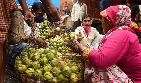 A fruit seller in a Kolkata market selling her stock. (Photo | PTI)