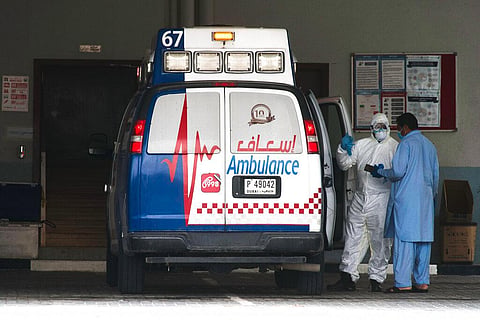 In this Thursday, April 16, 2020 photo, a paramedic speaks to a man at a labor camp in the Al Quoz neighborhood of Dubai, United Arab Emirates. (Photo | AP)