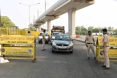 Police personnel stop commuters at Delhi-Faridabad border after all Haryana borders with Delhi were sealed during the nationwide in wake of the coronavirus pandemic in Faridabad. (Photo | PTI)