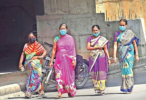 A group of women wears masks near Majestic Bus Stand, in Bengaluru, on Tuesday | PANDARINATH B