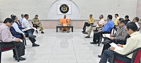 Yogi Adityanath at a meeting with officials in UP with social distancing norms in place. (Photo | Twitter)