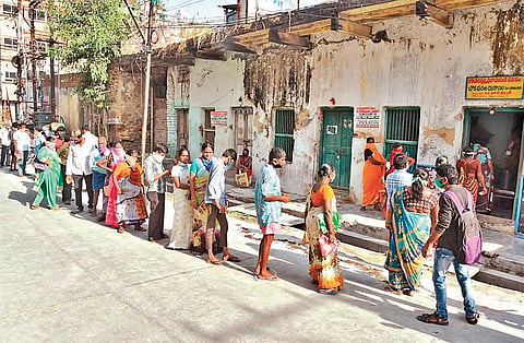 People waiting in a queue to collect ration in front of a fair price shop in Vijayawada on Wednesday (File photo | EPS)