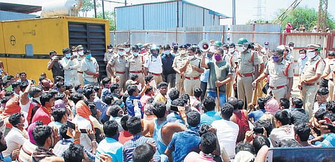Police try to pacify the agitated migrant workers at a construction site on IIT Hyderabad premises on Wednesday.