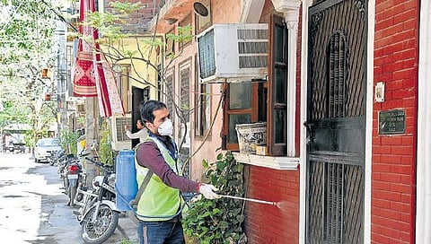 A MCD worker sanitises a residential colony in Lajpat Nagar. (Photo | Parveen Negi, EPS)