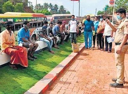 Migrants labourers at the inter-state border at Talapady after they were stopped by the police | Express