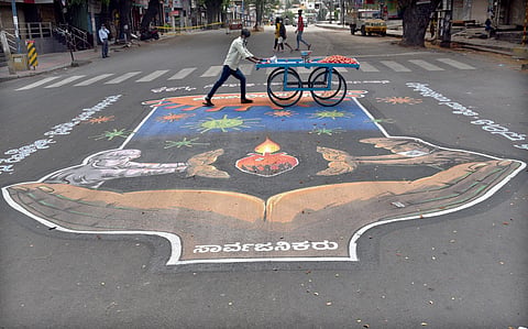 A venfor pushes his cart on a deserted street in Bengaluru. (Photo | Nagaraja Gadekal, EPS)