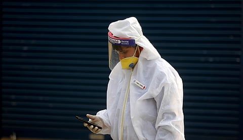 A petrol pump employee wearing personal protective equipment PPE kit at a fuel filling station in New Delhi on Thursday. (Photo | Shekhar Yadav/EPS)
