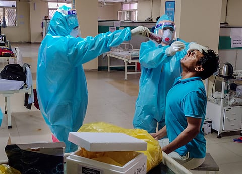 Medics check a COVID-19 patient who has completed mandatory 14-days of quarantine before his discharge at a hospital during the ongoing nationwide lockdown in New Delhi Sunday May 10 2020. (Photo | PTI)