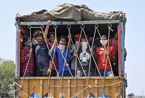 Migrants travel in a truck to reach their native places during ongoing COVID19 lockdown in Jabalpur Monday May 11 2020. (Photo | PTI)