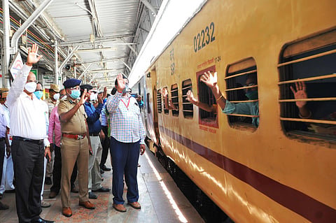 Migrant workers wave hands as the fourth Shramik special chugged off from Katpadi railway junction in Vellore district. (Photo | Express)