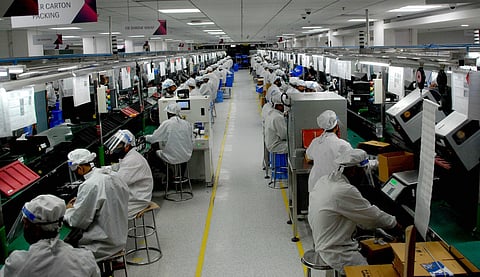 Employees at Lava mobile phone manufacturing unit resumed its operations after 40 days of closure due to the coronavirus-led lockdown in Noida Tuesday May 12 2020. (Photo | PTI)