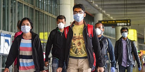 Passengers wear masks in the wake of coronavirus pandemic at the Kolkata airport. (File | PTI)