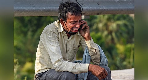 The powerful image of the distraught man, struggling to reach home in Begusarai, almost 1,200 km away during the nationwide lockdown, was widely shared across all media. (Photo | PTI)