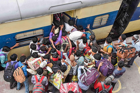 Migrants board a local train at Danapur railway station to reach their destination during the ongoing COVID-19 nationwide lockdown in Patna Saturday May 23 2020. (Photo | PTI)