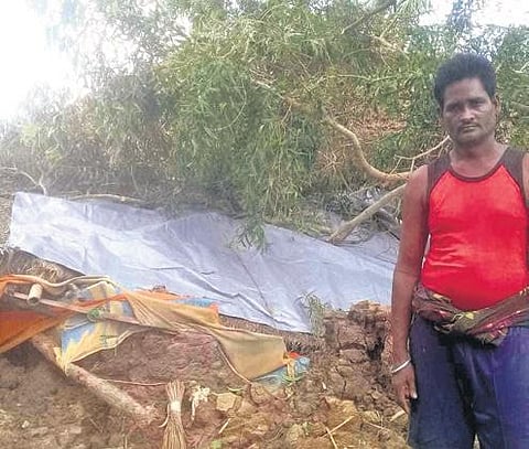 A man stands in front his house, damaged in cyclone Amphan, in Gupti village of Kendrapara district | Express