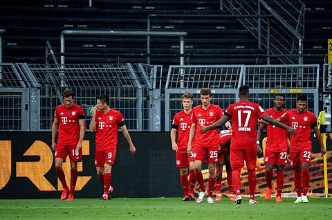 Bayern Munich's German midfielder Joshua Kimmich (3rd L) celebrates scoring with his team-mates during the German first division Bundesliga football match BVB Borussia Dortmund v FC Bayern Munich on May 26, 2020 in Dortmund, western Germany. (Photo | AFP)
