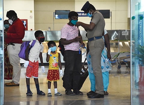 A family shows their E pass  at the exit gate of the arrival terminal at Chennai Airport. (Photo | EPS/Ashwin Prasath)