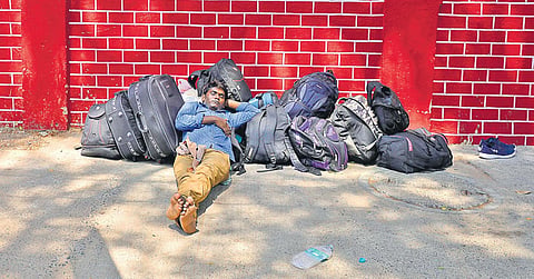 A migrant worker taking rest  while waiting for transportation to reach Chennai Central on Tuesday | DEBADATTA MALLICK