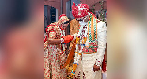 A couple wearing face masks during their marriage ceremony amid the ongoing COVID-19 nationwide lockdown in Bikaner. (Photo | PTI)