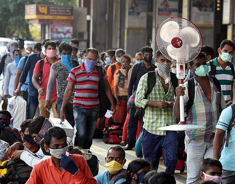 Migrants wait to board the special train to Odisha at Central railway station in Chennai on Wednesday. (Photo | Martin Louis/EPS)