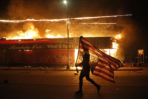 Protests over the death of George Floyd, a black man who died in police custody Monday, broke out in Minneapolis for a third straight night. (Photo | AP)