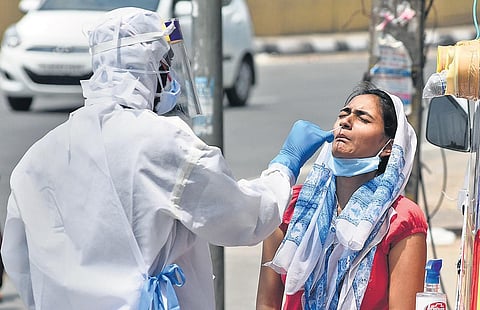 Health workers collect swab samples at a mobile Covid-19 testing van | Parveen Negi