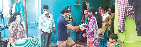 Volunteers distribute sanitary napkins to daily wage and migrant workers. (Photo| EPS)