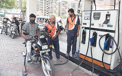 A biker gets his two-wheeler refueled at a petrol pump in New Delhi. The base price of petrol in Delhi on May 6 was Rs 19. But an additional almost Rs 50 was added in taxes, not to mention a dealer commission of Rs 3.60 (PHOTO | Parveen Negi)