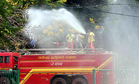 Fire Service personnel spray disinfectants in Bhubaneswar amid COVID-19 pandemic. (Photo | Irfana)