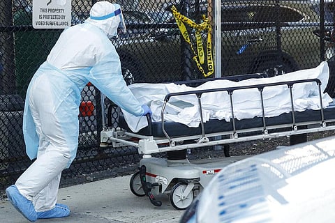 Image of a medical worker wearing personal protective equipment wheeling a dead body used for representationa purpose only (Photo | AP)