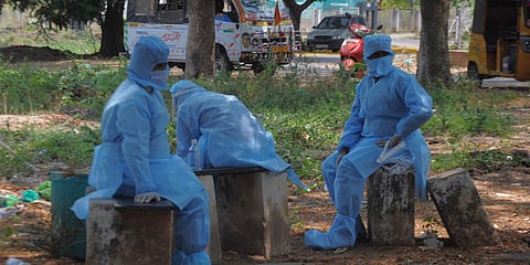 Sanitation workers, who carried a dead body waiting outside ESI hospital, while doctors conduct coronavirus test on the corpse. (Photo| Prasant Madugula, EPS)