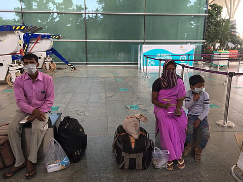 Migrant workers from Tamil Nadu heading to Chhattisgarh waiting for their flight at Kempegowda International Airport in Bengaluru. (Photo | EPS)