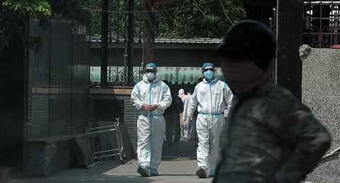 Health workers spotted wearing PPE kit while cremating a body of person who died of COVID-19 at the Punjabi Bagh crematorium in New Delhi. (Photo | Shekhar Yadav, EPS)