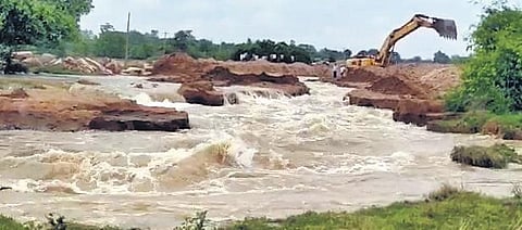 Repair work being taken up to fix the breach at an open canal that takes water from Mallanna Sagar surge pool to Kondapochamma reservoir on Friday