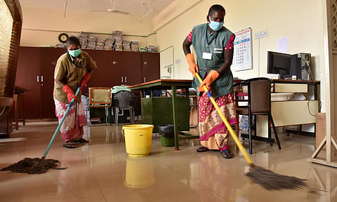Sanitary worker cleaning inside the Coimbatore Collectorate following the Goverment Order to sanitise and clean all goverment buildings on Second saturday of a month which is a holiday for Goverment Employess. (Photo | U Rakesh Kumar/EPS)