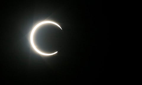 The moon partially covers the sun during an annular solar eclipse as seen in the Yemeni capital Sanaa. (Photo | AFP)