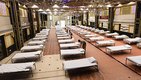 Rows of beds line in a hall at the Weddingz.in banquet hall in Kirti Nagar that has been converted into a temporary quarantine facility for people infected with the coronavirus in New Delhi on Monday. (Photo | Parveen Negi/EPS)