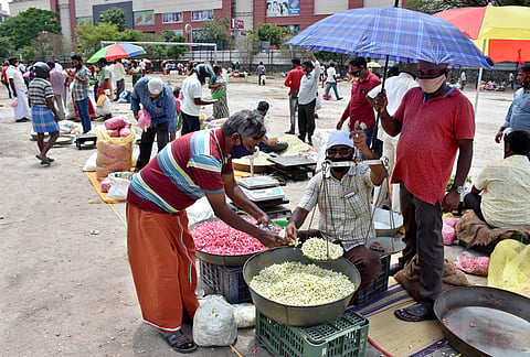 Traders of Flowermarket in Mettupalayam road set up their makeshift shops at Devanga Higher secondry School in Coimbatore on Wednesday. (Photo | U Rakesh Kumar/EPS)