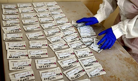 A health technician arranges COVID-19 rapid antigen kits after testing samples in Delhi. (Photo | PTI)