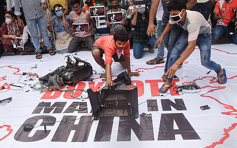 Activists smash Chinese products on a banner that reads 'Boycott Made In China' in Kolkata. (File Photo | PTI)