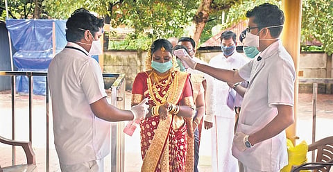 Health officials screening the bride and bridegroom for Covid-19 symptoms before the wedding at Guruvayur on Friday
