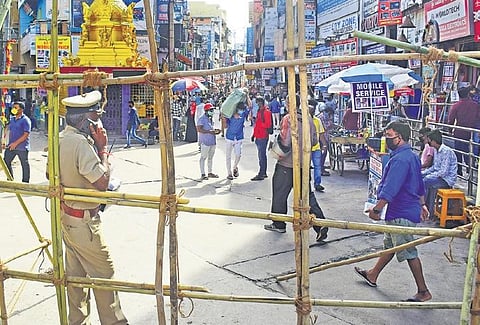 A police official monitors the situation on SP Road in Bengaluru on Saturday,  which was declared a containment zone recently | Pandarinath B