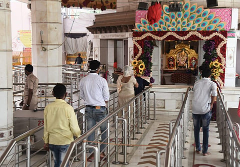 People gather at Jhandewalan Temple in Delhi on Monday to offer prayers as Government has allowed reopening of places of worship from today. (Photo | Parveen Negi/EPS)