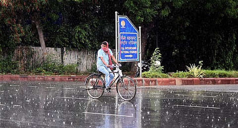 A commuter seen during rain as the capital gets monsoon shower at India Gate  on June 26, 2020 in New Delhi. (Photo | Parveen Negi, EPS)