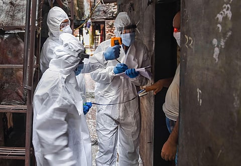 Health workers wearing PPE kits conduct door-to-door medical check-up of the residents of Dharavi slum amid COVID pandemic in Mumbai.  (File Photo | PTI)